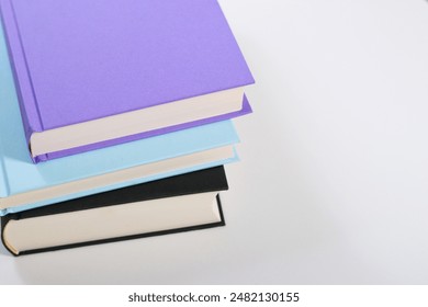 Close up mock up books stack on white table with copy space 