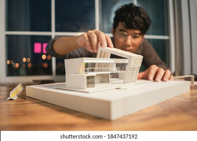 Close Up Model House Modern Style, Asian Man Architect Making Architecture Model Of House. Man Architect Working In The Office.