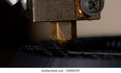 Close up of a modern 3D printer. Head of 3d printer in action. Close Up Of 3D Printer Operating In Design Studio - Powered by Shutterstock