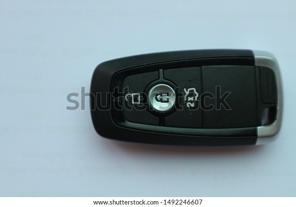 Close up a modern\
car key on white\
background