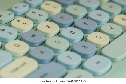 Close up of a modern computer keyboard with a cute, contemporary blue design seen from above.