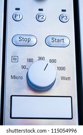 Close up of modern microwave control panel, blue light