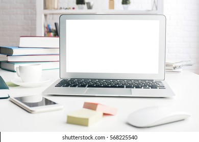 Close Up Of Modern Office Desktop With Blank White Notebook Screen, Smartphone, Coffee Cup, Supplies And Other Items. Mock Up