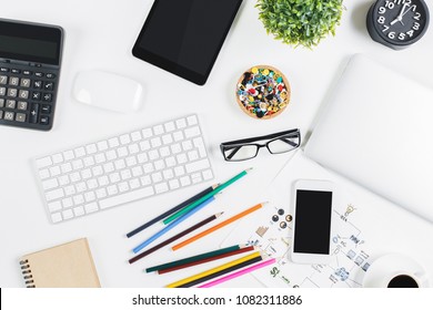 Close Up Of Modern Office Table With Empty Tablet, Smartphone And Laptop, Supplies And Other Items With Copy Space. Mock Up, Above View