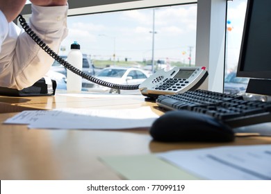 Close Up Of A Modern Office Workplace Desk Setup With A Computer Mouse Keyboard And Phone. Shallow Depth Of Field.