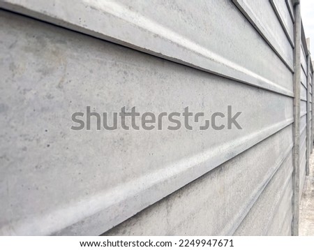 Close up modern prefab concrete fence Constructed from prefabricated concrete panels stacked together isolated on white background