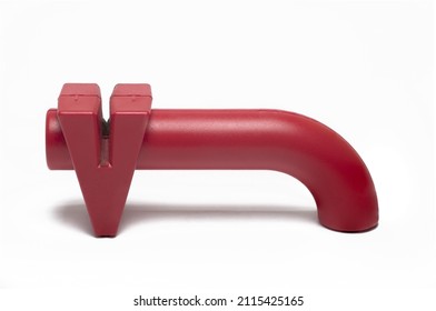 Close Up Of Modern Red Plastic Knife Sharpener Grinder For Pulling Through Dull Blades For Resharpening In Kitchen On White Background