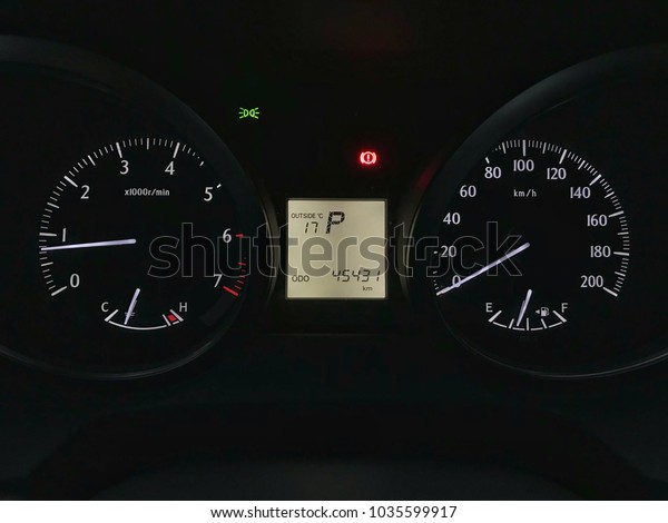 A\
close up of a modern RPM meter, speed meter, fuel indicator and\
with temperature digital indicator on a car’s\
dashboard
