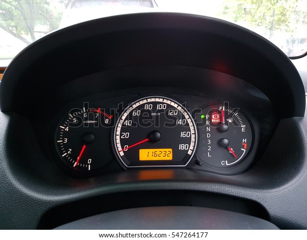 A close up of a modern RPM meter, speed meter,
fuel indicator and with temperature digital indicator on a car's
dashboard.