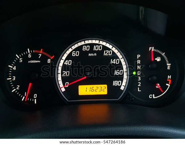 A close up of a modern RPM meter, speed meter,\
fuel indicator and with temperature digital indicator on a car\'s\
dashboard.