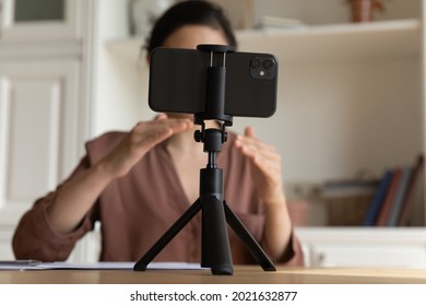 Close up of modern smartphone gadget record Indian female coach or speaker have webinar or video call. Ethnic woman talk speak on webcam digital virtual event on cellphone device. Technology concept.
