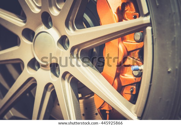 Close up of\
a modern sport wheel with orange\
brake