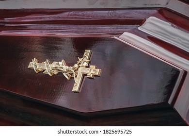 Close Up Of Modern Wooden Coffin With A Metal Crucifix