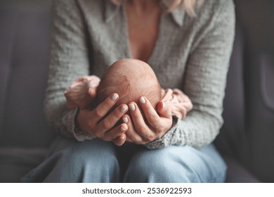 Close up mom gently cradling and rocking newborn baby in arms. Focus on hands holding baby, capturing tender, intimate moment of maternal care and love - Powered by Shutterstock