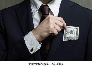 Close Up Of Money In Male Suit Pocket. Puts Money In Your Pocket