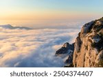 Close up of Montserrat mountain rocks with a sea of dreamy clouds and sunrise light