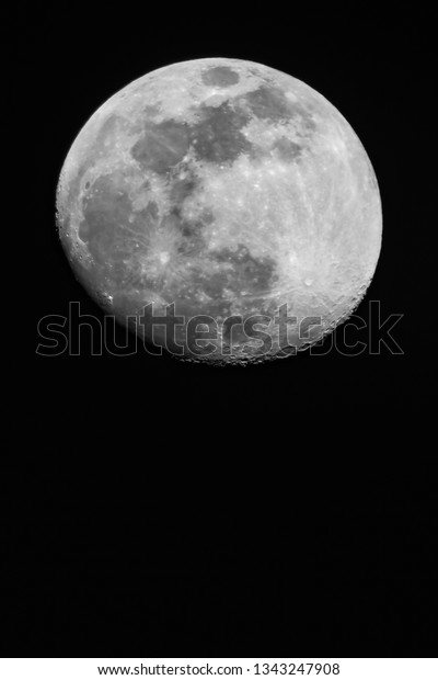 Close up moon surface, 95% Illumination of lunar\
disk before full moon seen from North hemispere, 700 mm focal\
lenght. Copy space for text on black vertical background.\
Astronomy, astrology,\
science.