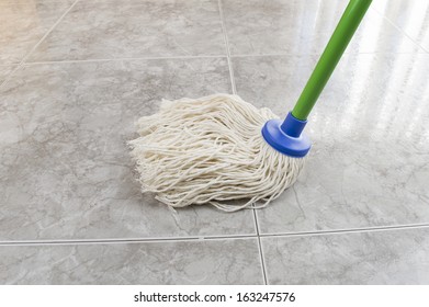 Close Up Of Mop Cleaning The Floor Marble