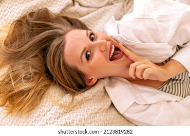 Close Up Moring Portrait Of Pretty Blonde Woman Laying On The Bed, Exited Face, Perfect Relaxing Time Alone.