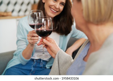 Close Up Of Mother And Adult Daughter Toasting In Wine