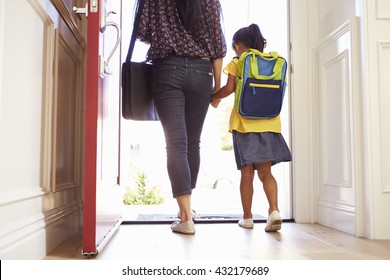 Close Up Of Mother And Daughter Leaving For School