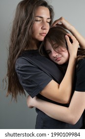 Close Up Of Mother Hugging Teenage Girl With Care And Love. Problems Awkward Age Concept. High Quality Photo