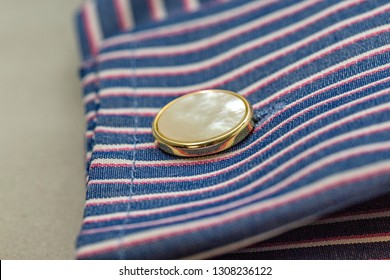 Close Up Of Mother Of Pearl Design Cufflink And Stripy Business Shirt