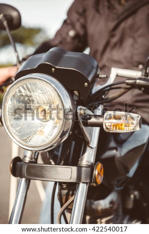 Motorcycle headlights with senior man steering