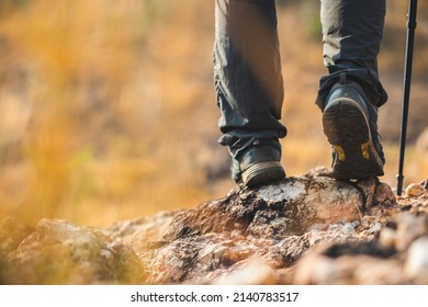 Close Up Mountaineering Boots Walking On Rocky Mountains At  Outdoor. Tourist Walks On Adventure Trip In Natural At Holidays. Travel Lifestyle Concept