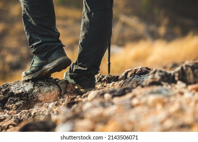 Close Up Mountaineering Boots Walking On Rocky Mountains At  Outdoor. Tourist Walks On Adventure Trip In Natural At Holidays. Travel Lifestyle Concept