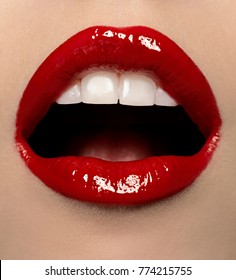 close up of mouth with red gloss and white teeth