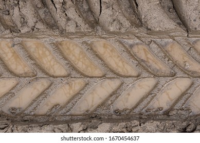 Close Up Of A Muddy Tractor Tire Track
