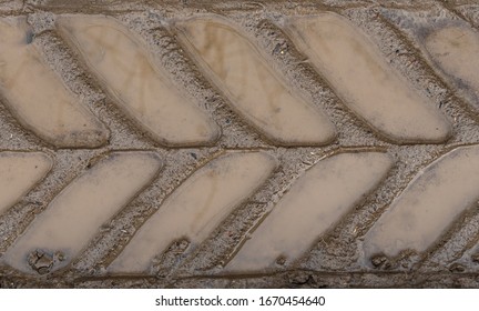 Close Up Of A Muddy Tractor Tire Track
