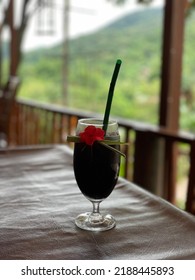 Close Up Mulberry Drink With Red Flower Decoration