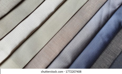 close up of multi cold color of silk fabric and linen samples. interior fabric material palette background. curtain or drapery samples.