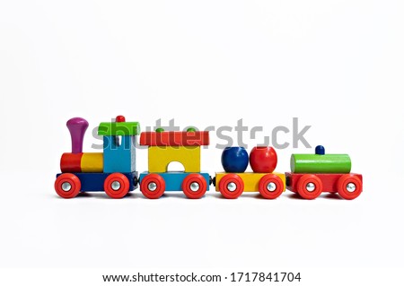 A close up of a multi-colored train toy on white background 