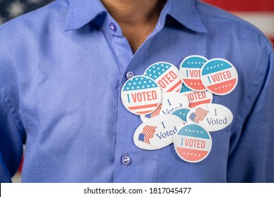 Close Up Of Multiple I Voted Stickers On Blue Shirt - Concept Of US Election Voter Fraud By Placing Multiple Voting Stickers