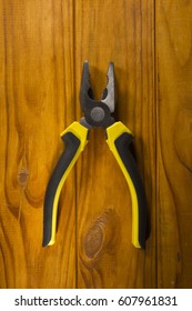 Close Up Of A Multitool Pliers On Wooden Background