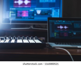 close up music machine with pads on the table sound work place with laptop and external monitor