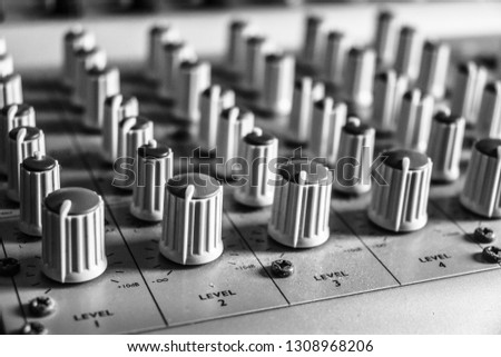 Close up of music mixing desk in black & white