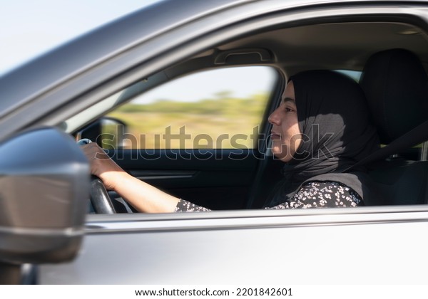 Close up of muslim woman\
driving a car
