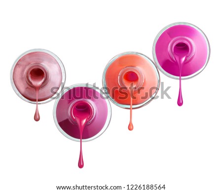 close up of  a nail polish bottle and drop on white background