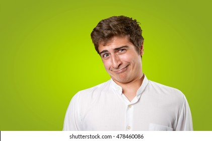 Close Up Of A Naughty Young Man On Green Background