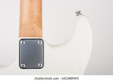 Close Up Of Neck Plate On White Electric Guitar With Bolt On Neck , Rear View, Studio Shoot.  