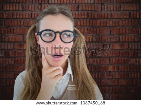 Close up of nerd woman thinking against brick wall