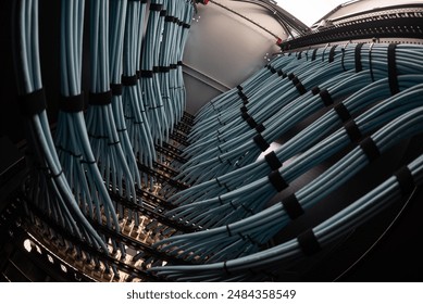 close up of network cables connected to server racks in data center room.