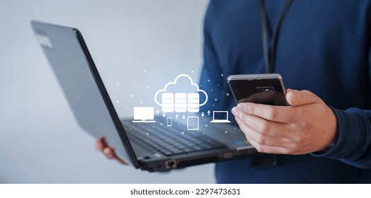 close up network engineer man hand hold smartphone to contact team about installation and synchronize data for backup on cloud computing network in operation room with virtual system for techno - Powered by Shutterstock