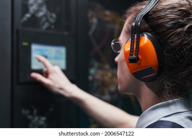 Close up of network engineer operating server cabinet via digital control panel in data center, copy space