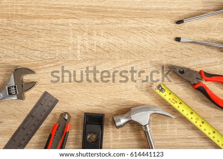 Close up new of assorted work tools on wood with copy space for text.