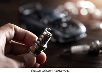 Close up new automotive spark plug. Car maintenance concept.  - Shutterstock ID 2052490334